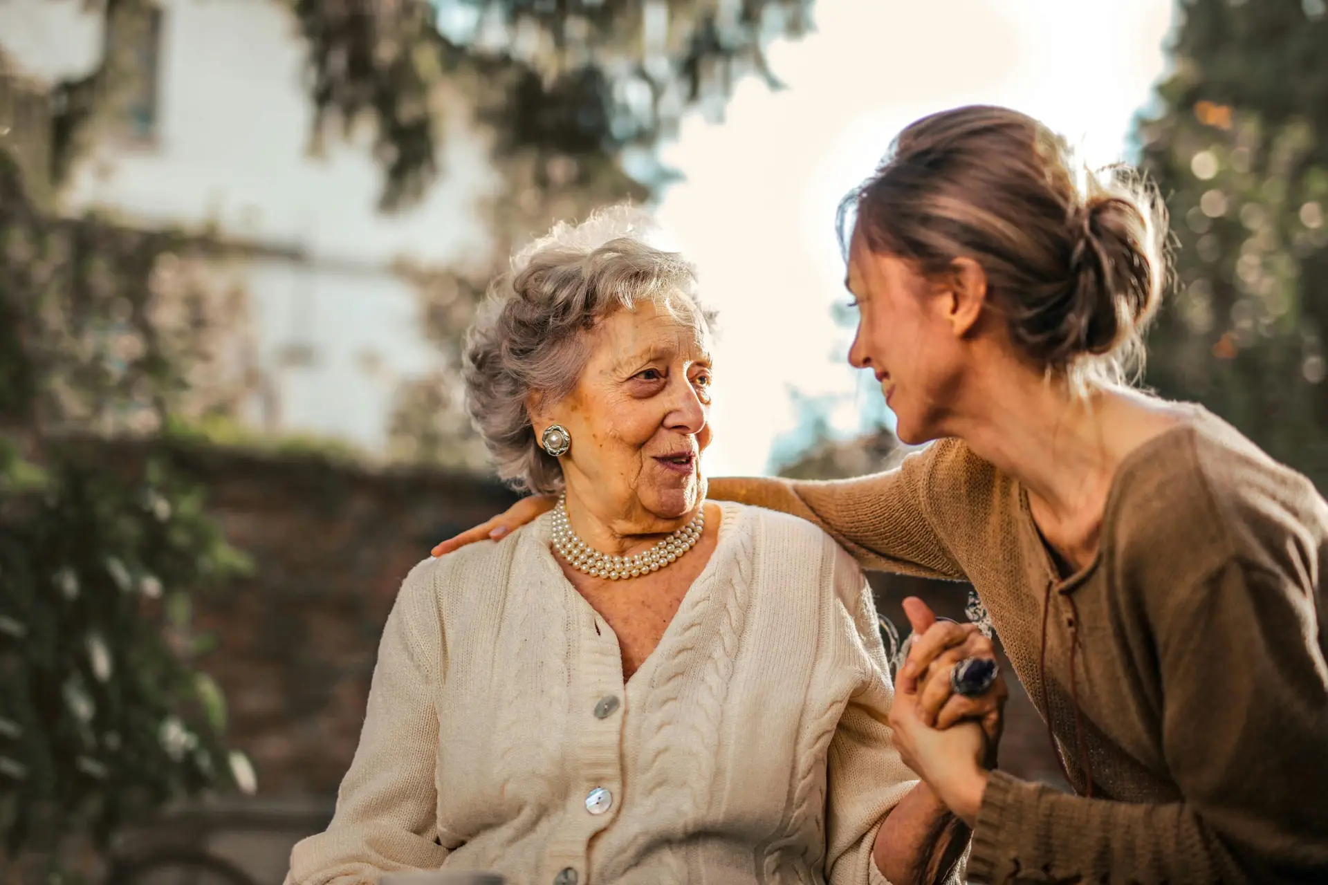 Support worker engaging with an elderly woman, highlighting NDIS disability support services and community participation in Perth.